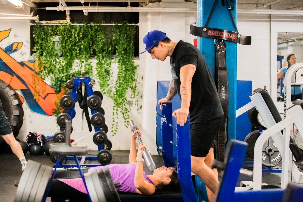 Local Fit trainer coaching a client during a workout
